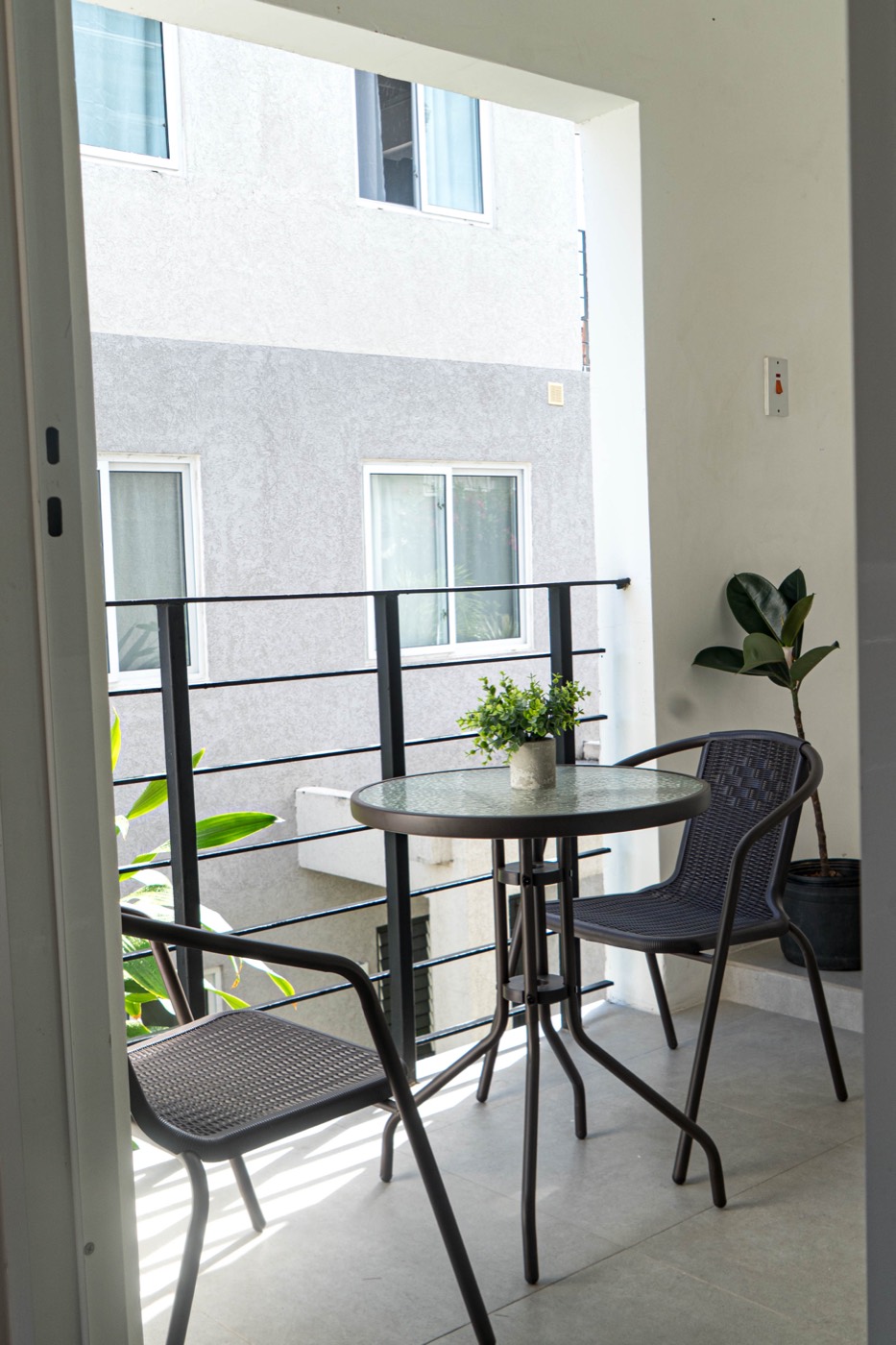 Balcony with a round bistro table and two chairs
